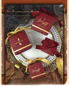 Detail of red wedding candy gift boxes with gold foil stamping and elegant bow ribbons