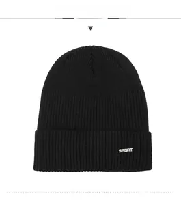 Detail view of black ribbed knit beanie with SPORT lettering and folded cuff design