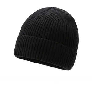 Detailed view of black knitted beanie with 'SPORT' patch and ribbed texture