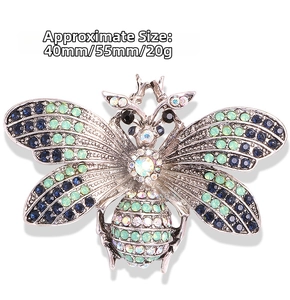 Detail of bee brooch featuring vibrant blue and green crystals with 40mm x 55mm dimensions