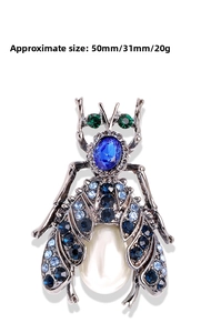 Detail showing beetle brooch with blue crystals and pearl in 50mm x 31mm scale