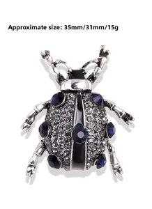 Detail view of beetle brooch with dimensions 35mm x 31mm and blue crystal rhinestones