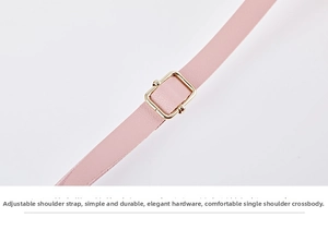 Detail of pink woven leather adjustable shoulder strap with golden metal buckle