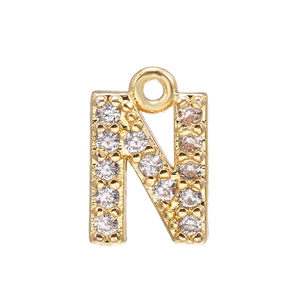 Macro shot of 18k gold plated letter N pendant with pavé cubic zirconia inlay details