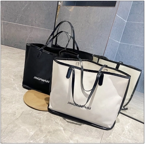 Close-up of black and cream tote bags with dual straps and Jingpinpiju lettering