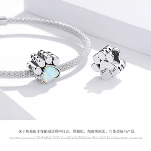Detail of S925 silver paw charm with heart opal and Run Free engraving on the back
