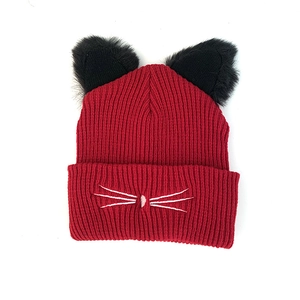 Red knit beanie featuring cute plush cat ears and white embroidered whiskers detail