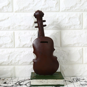 Vintage violin decorative money box on retro book with classic brown finish for home decor