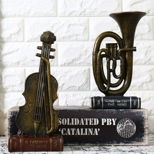 Vintage instrument ornaments featuring violin and tuba on book-shaped bases