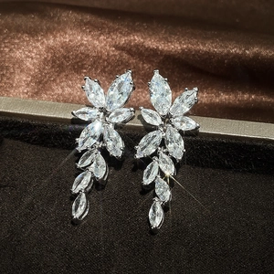 Elegant silver teardrop earrings with marquise-cut marquise stones on brown velvet