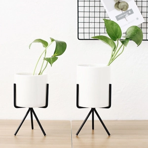 Set of two minimalist white ceramic planters with industrial black metal tripod stands