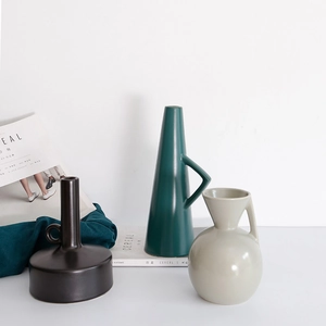 Three modern Nordic ceramic vases in black, dark green and grey with geometric handle designs