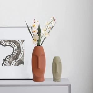 Nordic Morandi abstract face ceramic vases set with white orchids in a modern room