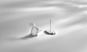 Macro shot of 925 sterling silver carrot rabbit asymmetric stud earrings with 925 hallmark