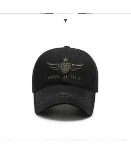 Close-up of golden Ray Wolf shield embroidery on black cotton twill baseball cap