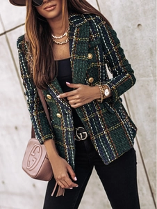 Detailed close-up of green plaid tweed blazer featuring golden embossed buttons