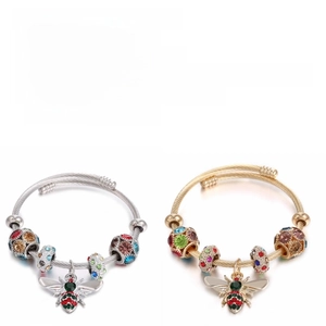 Detailed comparison of gold and silver bee bracelets with colorful rhinestones and enamel