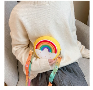 Detail of yellow silicone round kids bag with rainbow pattern and colorful printed strap