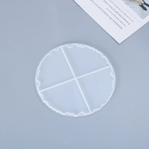 Top view of a round silicone coaster mold with four-compartment cross divider and wavy edge