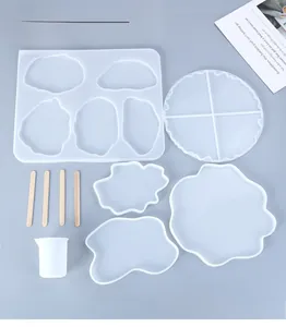 Macro view of 5-piece silicone resin coaster mold set with measuring cup and wood sticks