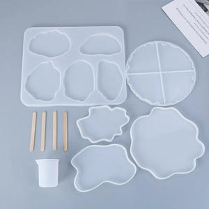 Detail view of 5-piece epoxy resin coaster molds set with mixing sticks and measuring cup