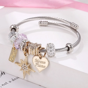 Silver woven steel bracelet with gold star charm and purple crystal bead detail