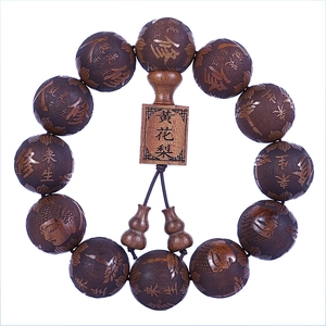 Bracciale buddista in legno intagliato con scritture e motivi di loto