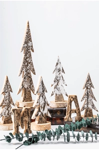 Macro detail of natural birch wood Christmas tree ornaments with white snow paint texture