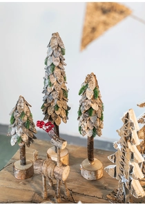 Detail of wooden Christmas tree ornaments with natural bark texture and wooden reindeer