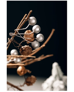 Macro detail of silver berries and natural pine cones for festive floral arrangements