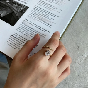 Detailed view of gold 925 sterling silver open ring with a pear-cut teardrop gemstone
