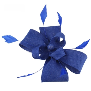 Detail of blue Sinamay fascinator hat with elegant feathers and layered bow design
