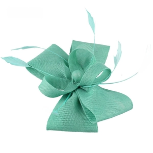 Detailed close-up of teal Sinamay fascinator with elegant feathers for wedding guests