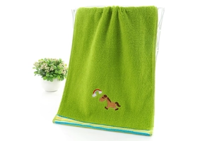 Close-up of soft cotton kids towel featuring cute pony and rainbow embroidery detail