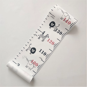 Close-up of wooden growth chart featuring cute cartoon lion, elephant and zebra patterns
