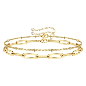 Double-layered gold paperclip chain bracelet with bead details and zircon pendant