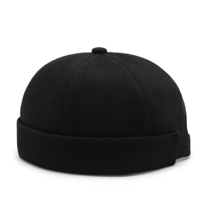 Minimalist black cotton docker cap with a retro six-panel design and folded brim