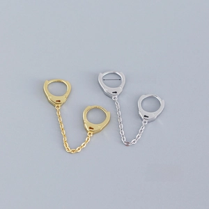 Detail of S925 silver cuff earrings with lock chain link in gold and silver finish