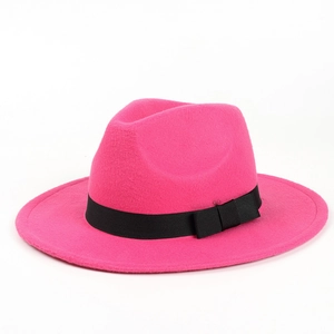Detail of rose red wool fedora hat with a black grosgrain ribbon and classic bow tie