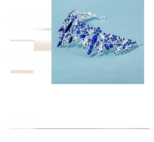 Detail of silver bridal tiara with blue leaf-shaped crystals and vintage floral design