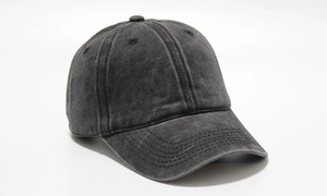 Close-up of washed cotton fabric texture and stitching details on a charcoal baseball cap