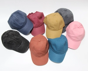 Flat lay of vintage washed cotton baseball caps in eight vibrant colors on white background