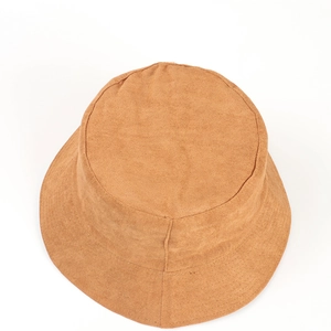 Macro detail of camel faux suede bucket hat showing premium stitching and soft texture