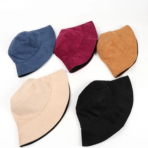 Flat lay of double-sided suede bucket hats in various colors for men and women