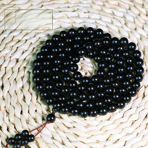 Detailed close-up of 10mm African Blackwood Buddhist prayer beads with 108 beads
