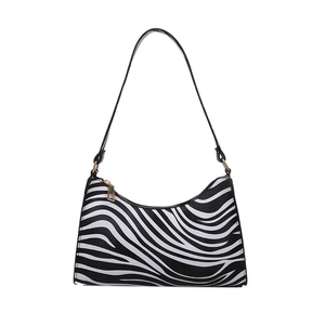 Fashionable zebra print shoulder bag with sleek curved silhouette and gold hardware accents