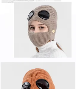 Detail of knit aviator hat with goggles and mask featuring thick warm wool and wood button