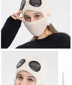 Close-up of knit aviator balaclava with integrated goggles and yellow button details