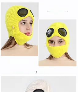 Detail of yellow knit pilot beanie with integrated goggles and warm face mask structure