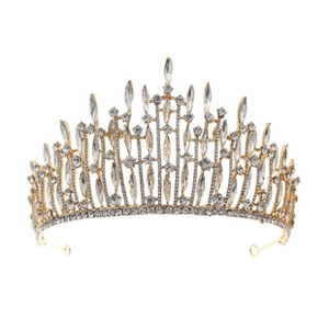 Macro shot of gold alloy wedding crown with shimmering teardrop and round rhinestones